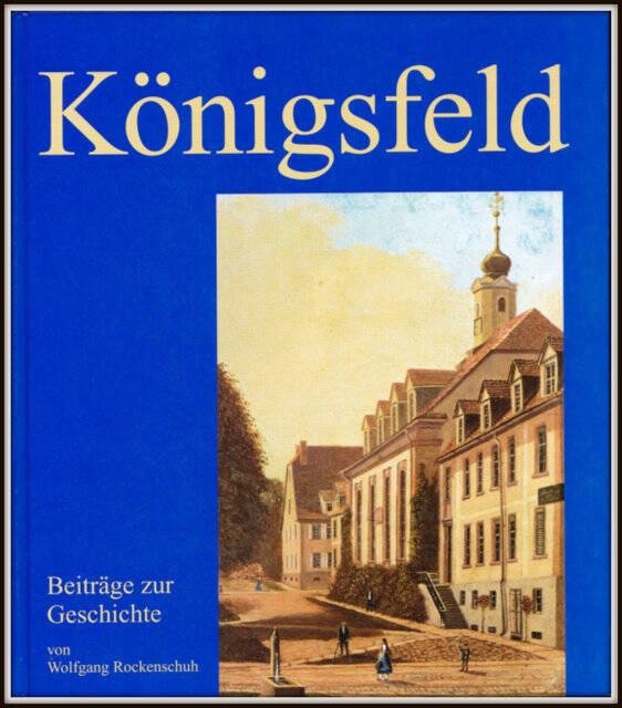 Das Cover eines Buches mit dem Titel "Königsfeld" zeigt eine historische Abbildung eines Gebäudekomplexes mit einem Kirchturm und Personen auf einer Straße davor.